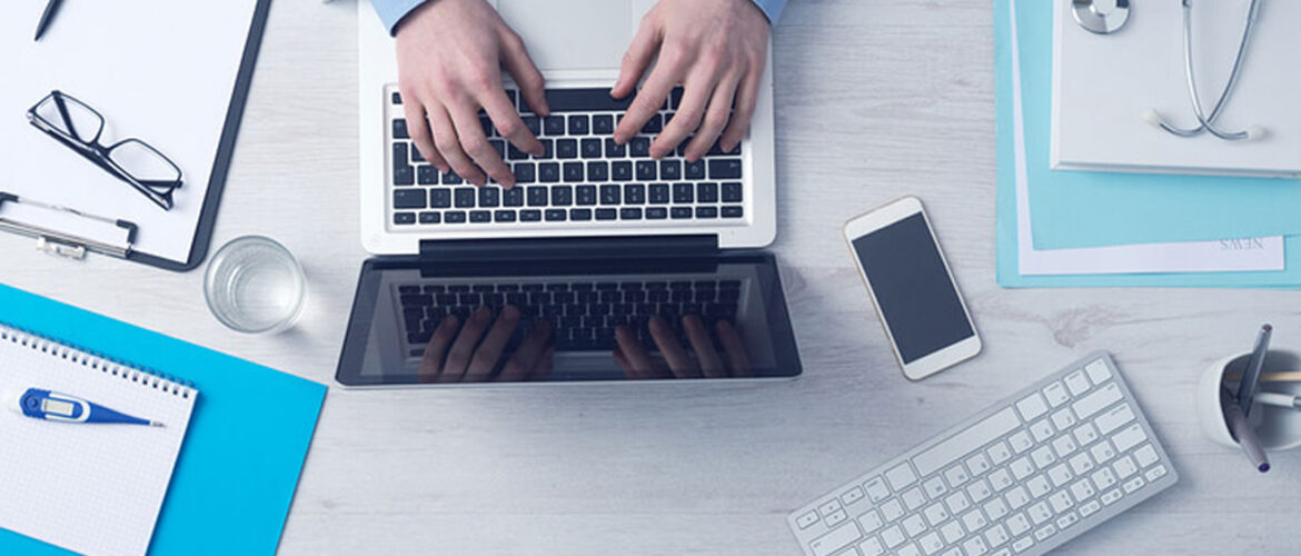 Image showing two hands working on laptop on a table